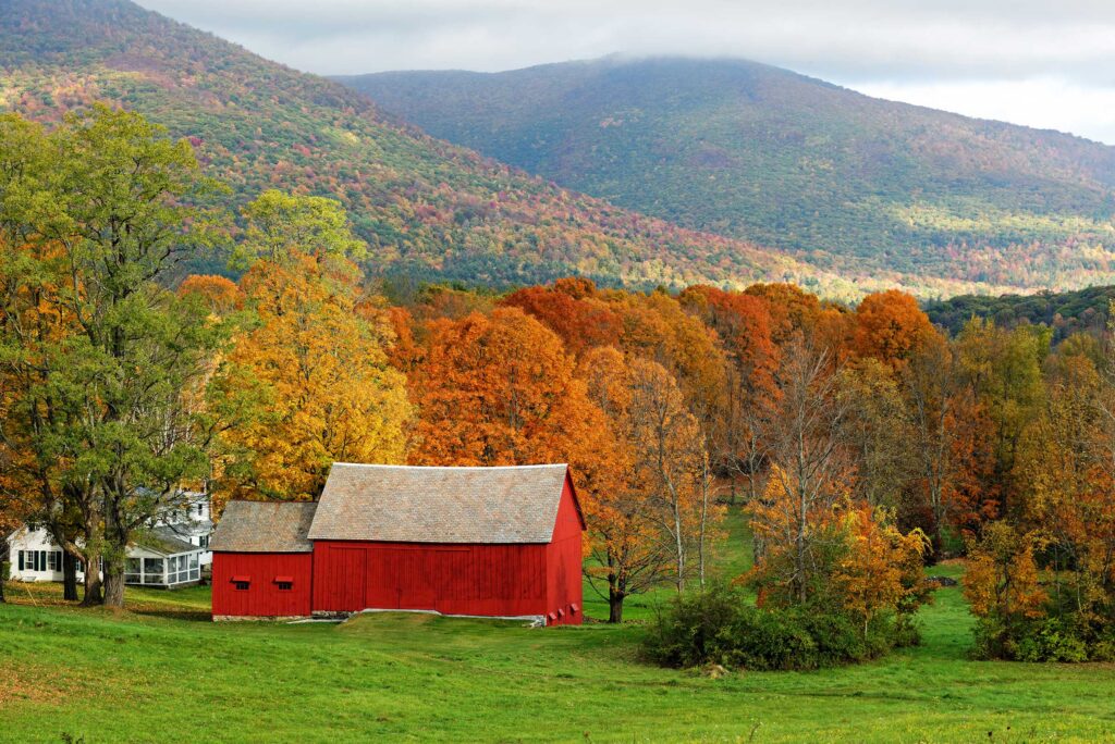 A red barn surrounded by fall foliage in Vermont