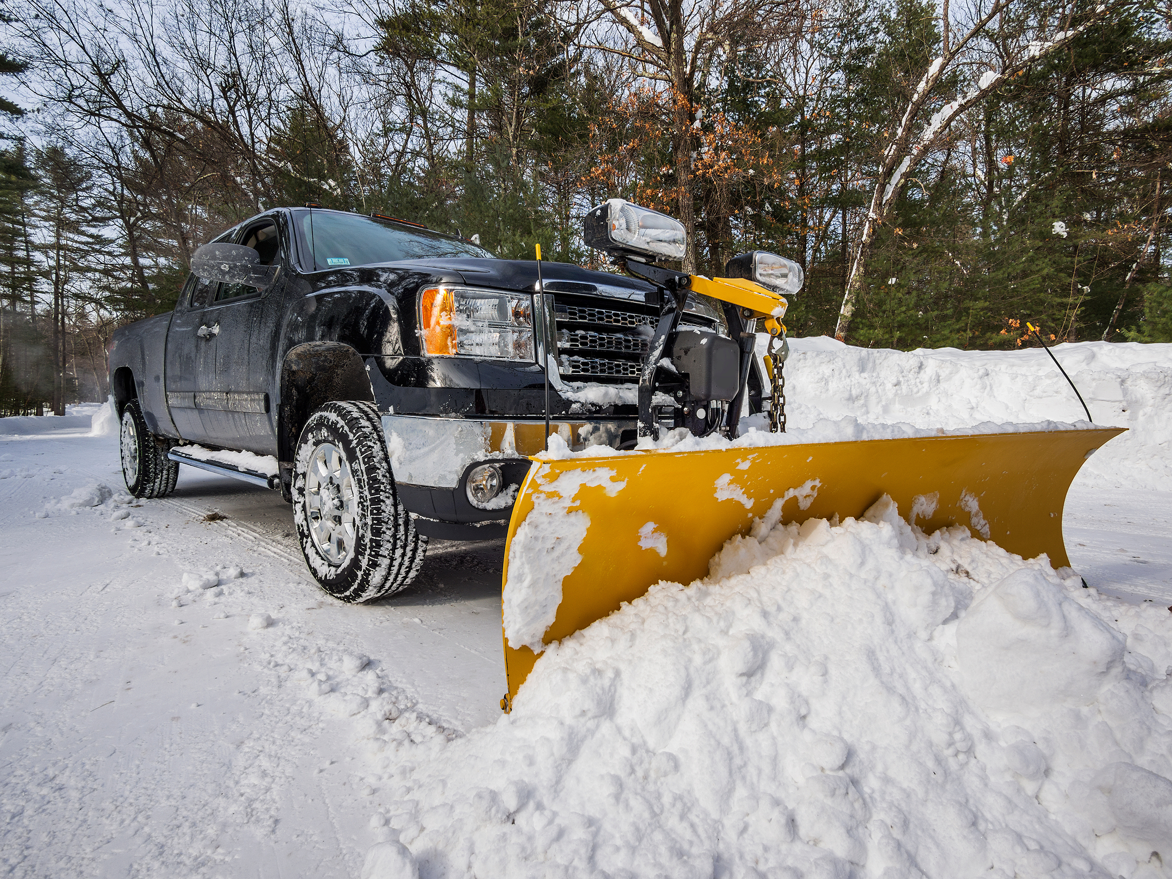 A sugarhouse property services snow plow at work plowing snow in vermont
