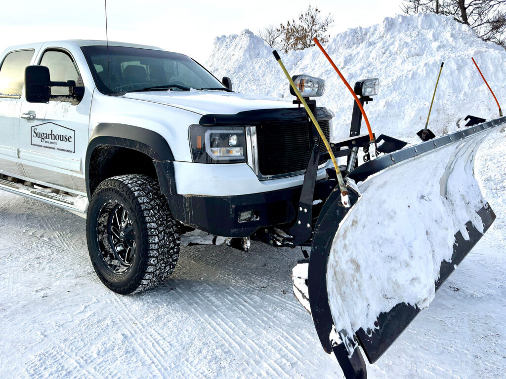 Snowplowing with a Sugarhouse Vermont logo on a white truck