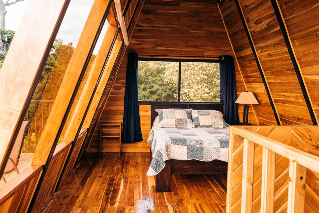 Cozy log cabin bedroom with a freshly made bed, ready for the next guests