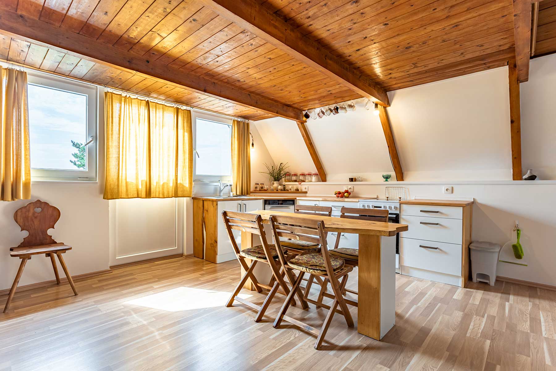 Wood-paneled vacation cottage with an open kitchen and living area